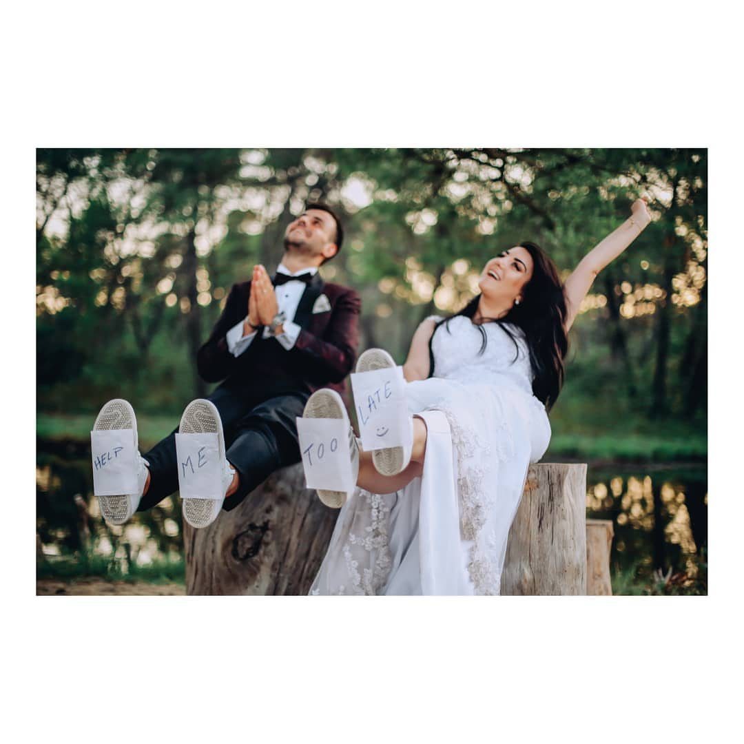 Bride and groom sitting on a log with funny messages on their shoes.