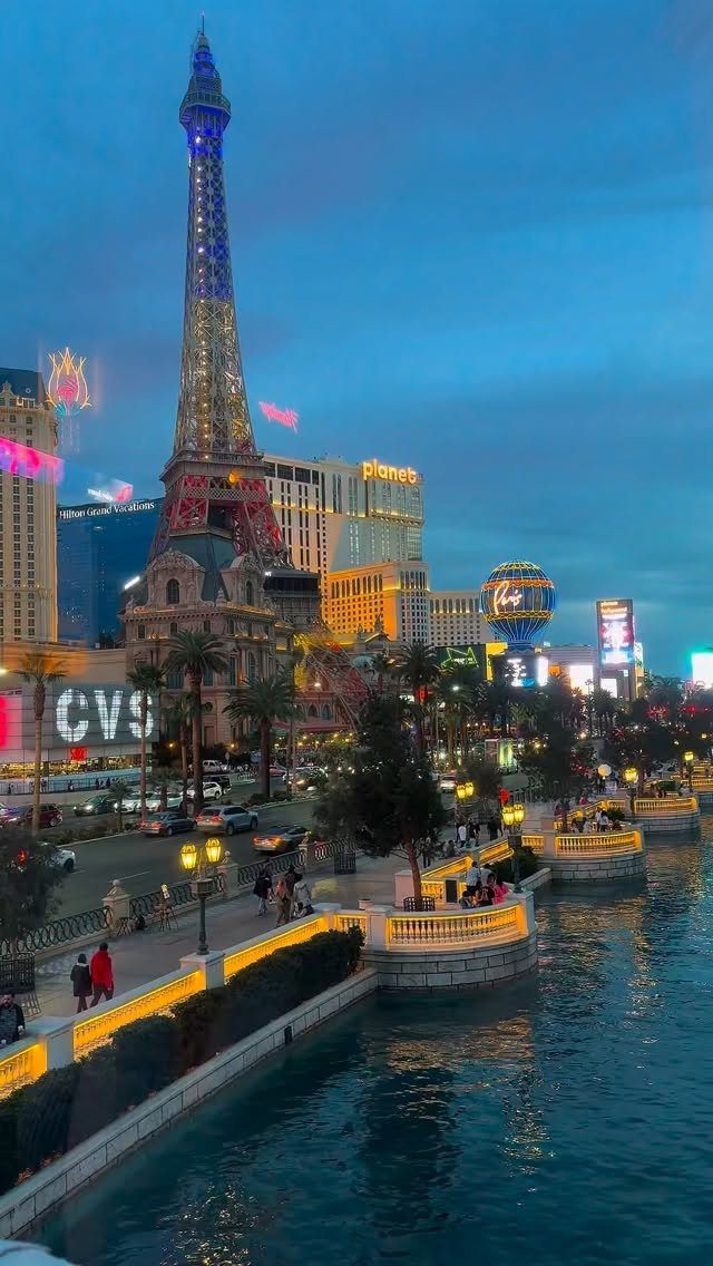 Eiffel Tower replica and illuminated city skyline overlooking a canal in Las Vegas