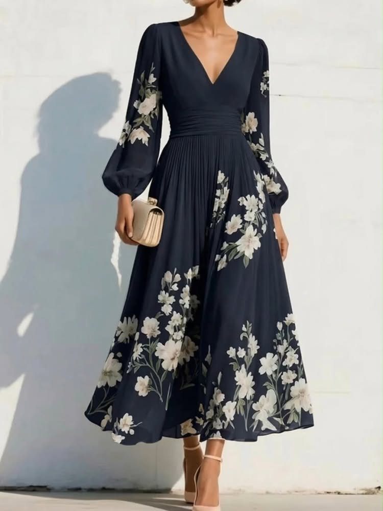 Woman in navy blue floral midi dress with nude heels and beige clutch