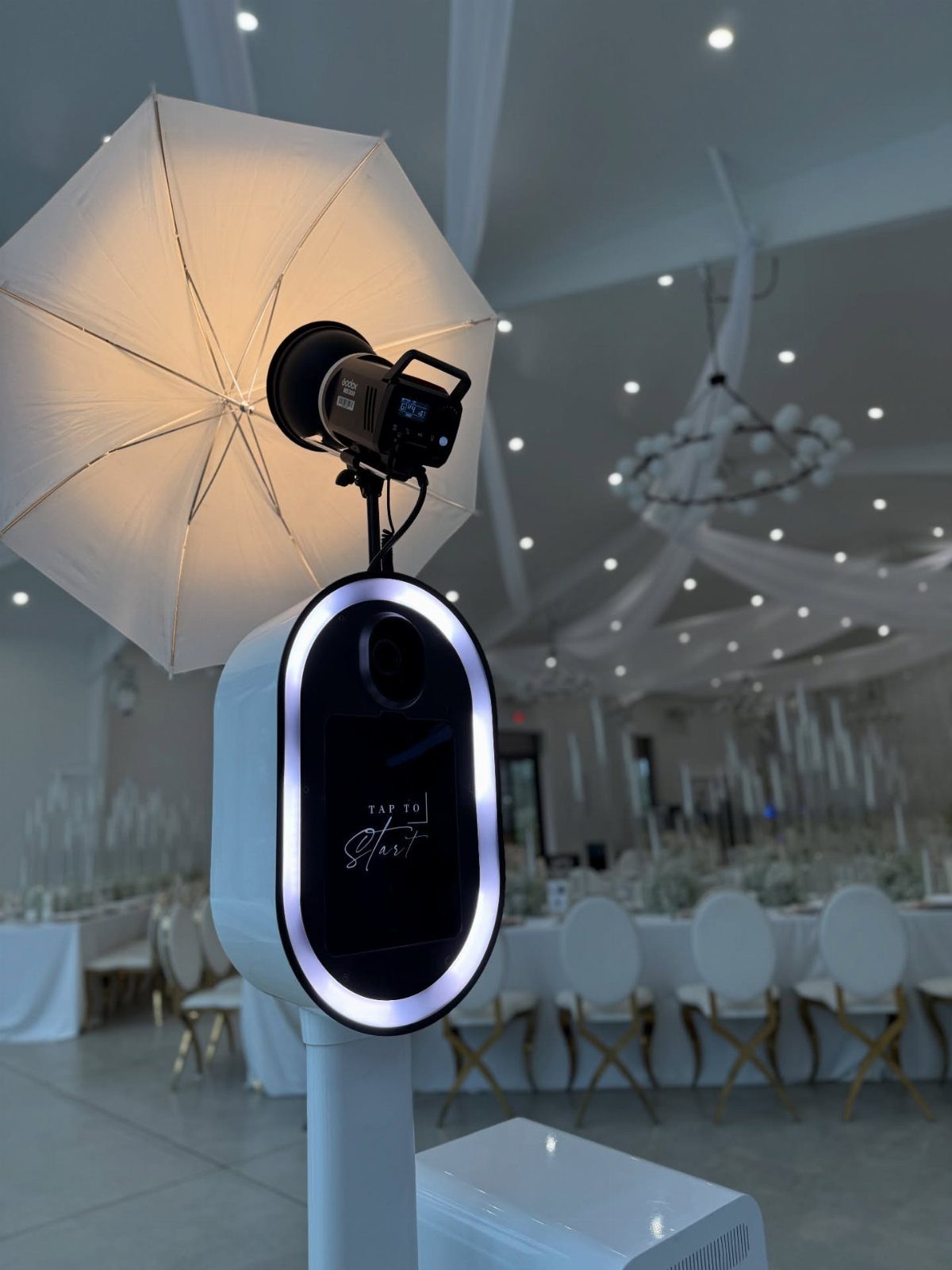 Digital photo booth with a white umbrella flash in a wedding reception hall