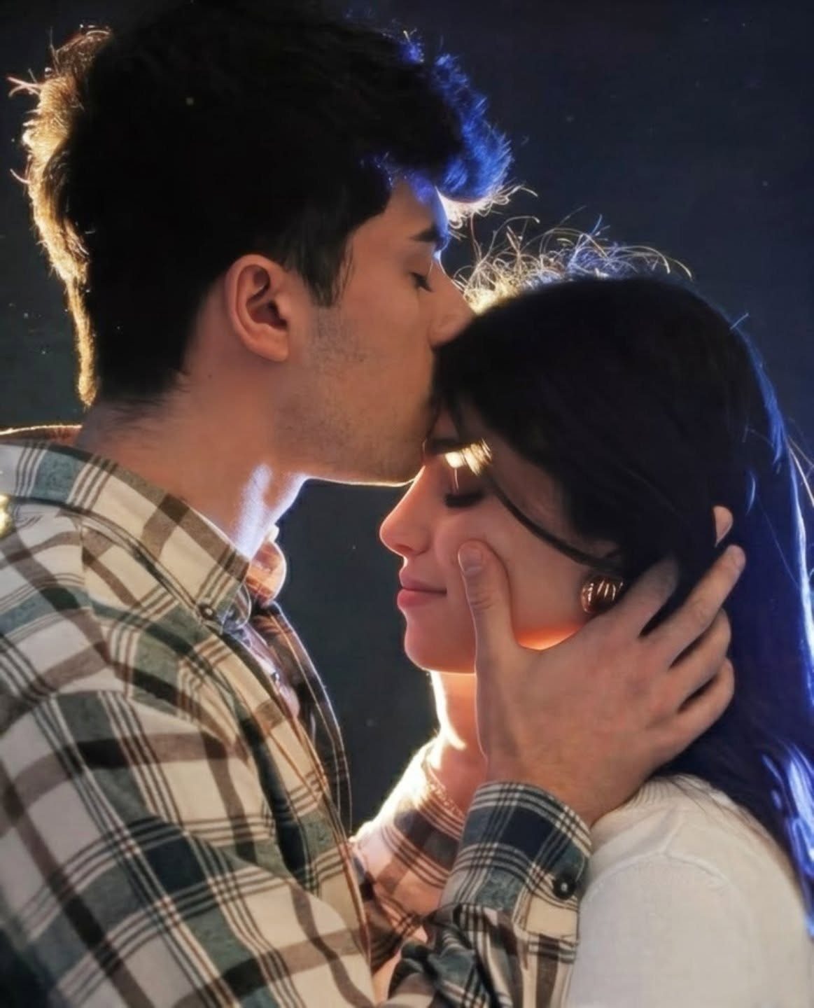 Man in plaid shirt kissing a woman's forehead while cupping her face.