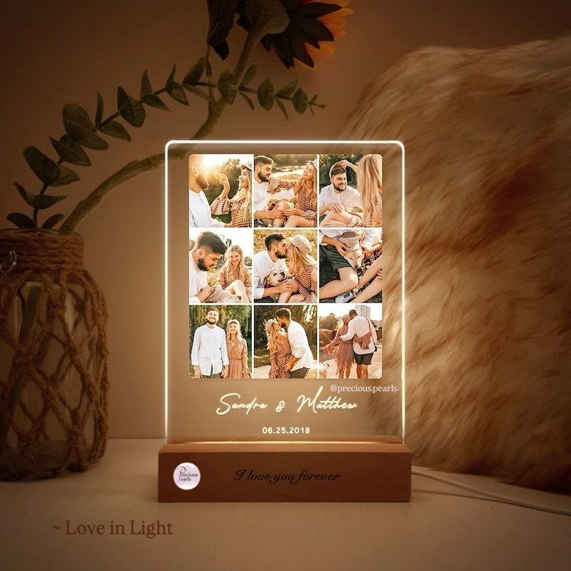 Illuminated acrylic photo plaque with a grid of couple photos on wooden base
