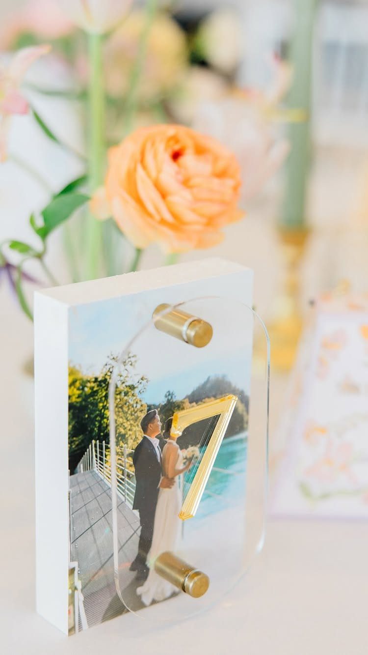 Wedding table number seven featuring a photo of a couple on a bridge.