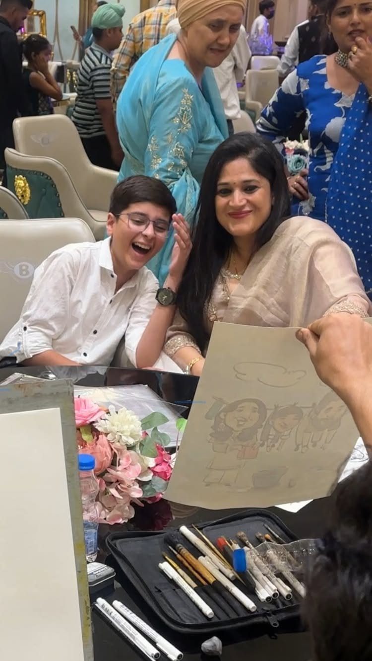 Woman and young man laughing at a caricature drawing during a wedding event.