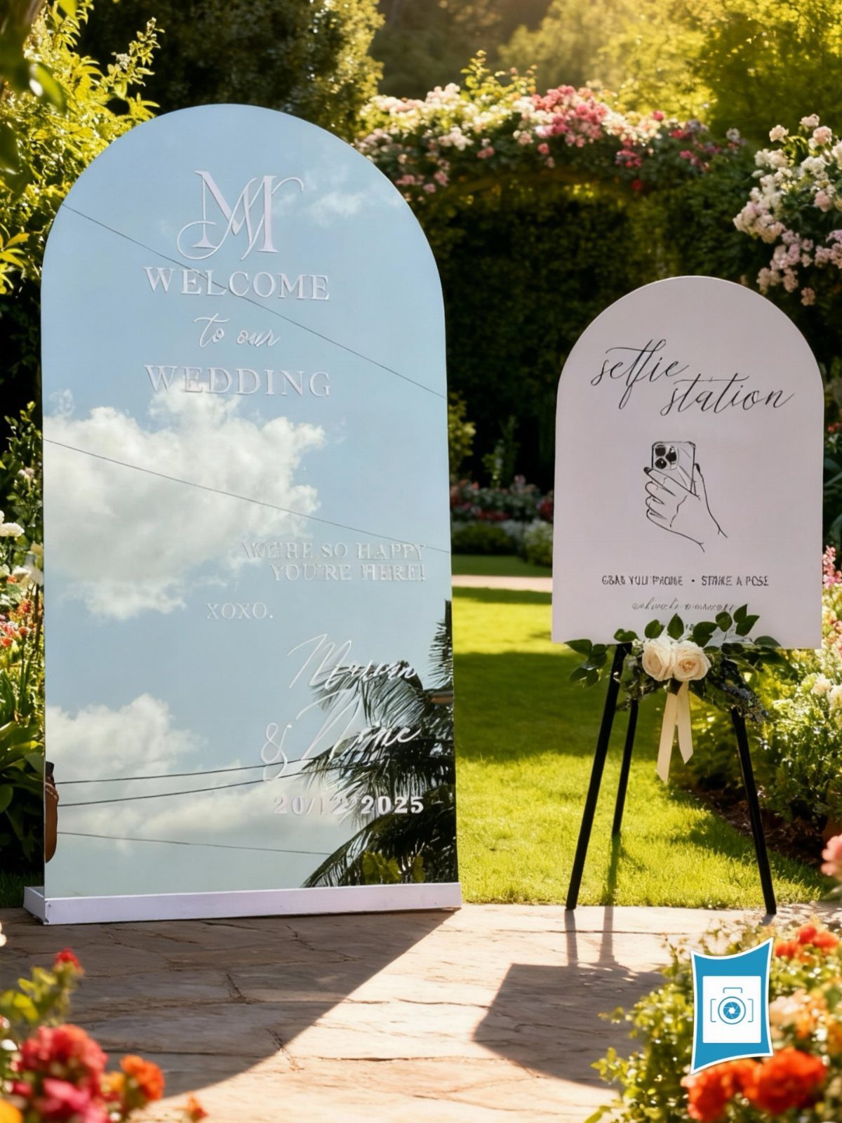Selfie station sign on an easel next to a wedding welcome arch outdoors.